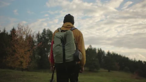 A hiker walking in nature carrying backpack. Stock Footage 220188975