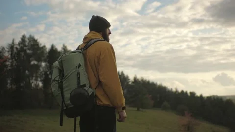 A hiker walking in nature carrying backpack. Stock Footage 220189012