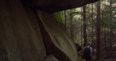 Hiker Walking Past Massive Sandstone Rocks In Czech Paradise Forest Vídeo Stock 345104301
