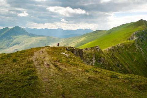 Hiker walking on ridge path Stock Photos