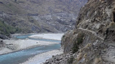 Hiker walking on thin path on steep mountain slope Video stock 67647579