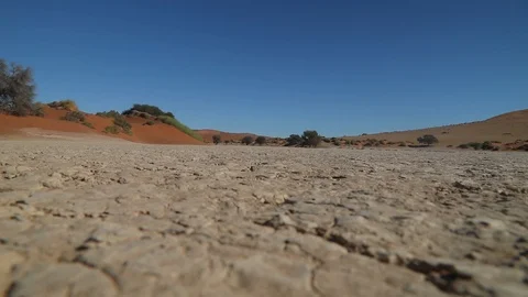 Hiker walking through clay or salt pan near deadvlei in Sossusvlei, Namibia Stock Footage 102760619