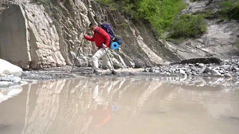 Hiker Walking Through Rocky Mountain Stream Video stock 308961890