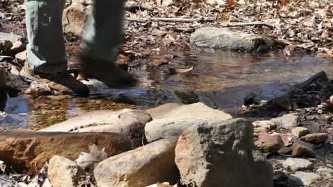 Hiker Walking Through Stream Slow Motion Video stock 236337164