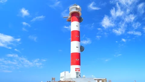A hiker walks at the base of the Lighthouse of Punta de La Rasca, Tenerife Stock Footage 204893699