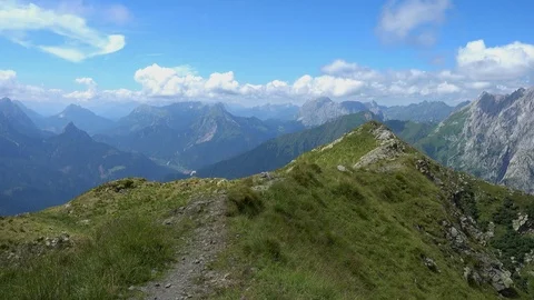 Hiker walks on the crest of the mountain with a splendid panorama. Stock Footage 121313582