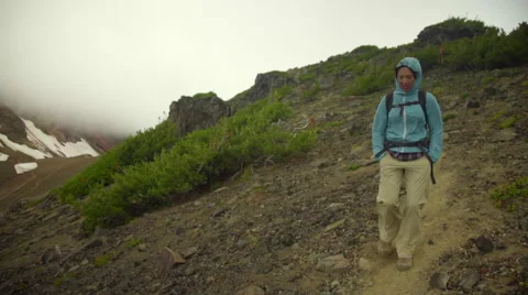 Hiker walks down from mountain top Stock Footage 59518286