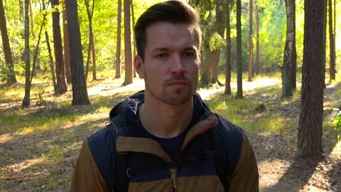 A hiker walks down a path through a forest - closeup 스톡 동영상 109334727