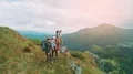The hikers are standing on the mountain slope 4k or 4k+ Resolution