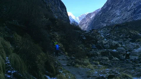 Hikers with backpack go on mountain valley road. Himalayas Nepal nature HD video Stock Footage 64828827