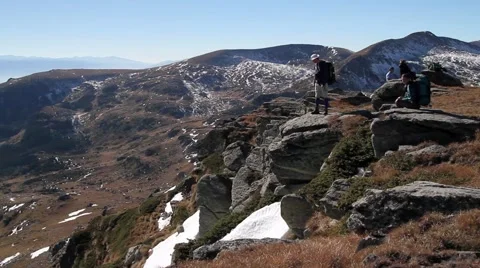 Hikers with backpack standing on top of a mountain Stock Footage 40254661