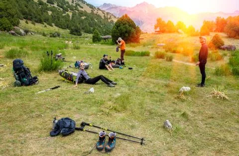 Hikers break on grassy lawn Stock Photos