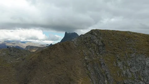 Hikers Contemplating Midi d'Ossau in the Pyrenees Mountains Stock Footage 345043737