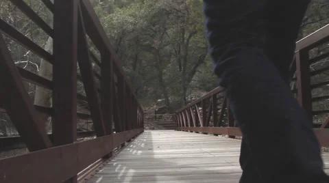Hikers Crossing a Bridge Stock Footage 48017240