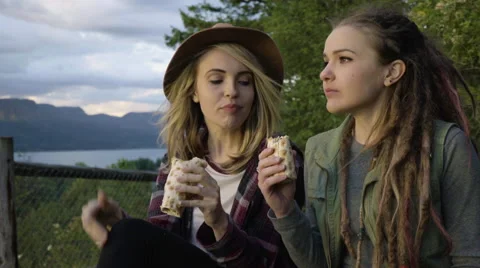 Hikers Eat At An Overlook, She Throws Grape And Tries To Catch It In Mouth Stock Footage