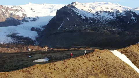 Hikers on the edge of a Mountain | ICELAND Stock Footage 154427992