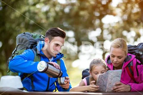 Hikers father is thirsty from hiking. Stock Photos