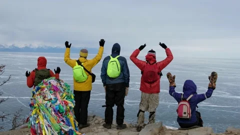 Hikers going to top and looking at ice of Baikal. hands up Stock Footage 145630123