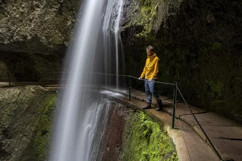 Hikers at Levada Nova Nova waterfall and Moinho in a gorge long exposure Ponta Stock Photos