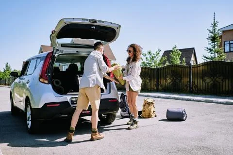 Hikers loading stuff into car Stock Photos