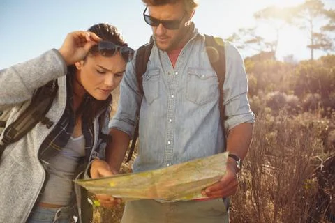 Hikers looking at map for navigation Stock Photos