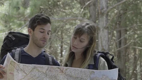 Hikers looking at map in woods Stock Footage 75199362