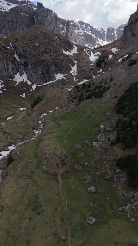 Hikers on Mountain Trail in Spring Malaesti Valley Bucegi Aerial Stock Footage 333982989