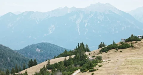Hikers passing mountain top on a cloudy day in Alps Stock Footage 220466649