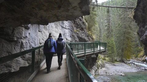 Hikers on path in Johnson Canyon Banff Canada Stock Footage 122097534