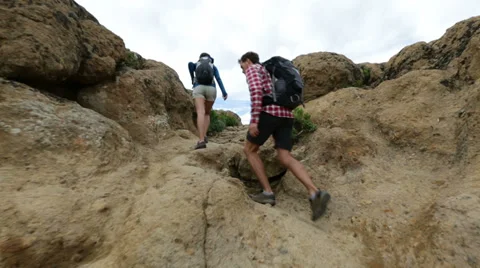Hikers reaching summit top after ascent Stock Footage 37680687