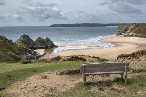 Hikers resting bench at Three Cliffs Bay Wales Stock Photos