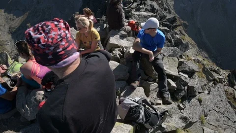 Hikers resting on a mountain summit Stock Footage 95486879