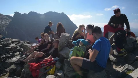 Hikers resting on a mountain summit Stock Footage 95487894