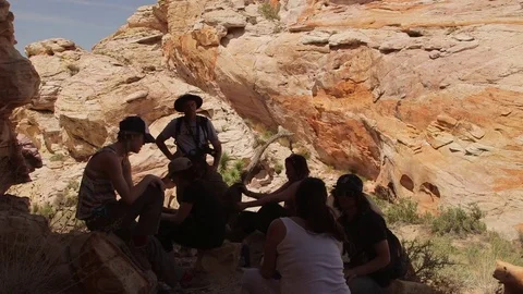Hikers resting in shade at Gold Butte National Monument Stock Footage