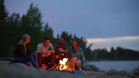 Hikers roasting marshmallows at night Stock Footage 115278772