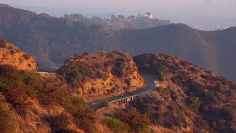 Hikers on Scenic Pathway with Griffith Observatory and Hillside Views Stock Footage 295604110