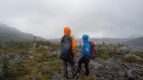 Hikers scouting route during wind storm in Patagonia Stock Footage 123384222