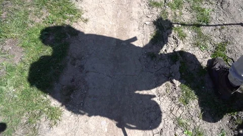Hiker’s Shadow Moving on Ground 動画素材 303662102