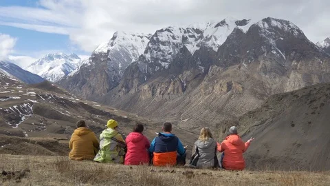 Hikers sit back and look at the mountain valley Video stock 87600523