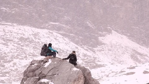 Hikers sitting in a snow storm Stock Footage 101986660