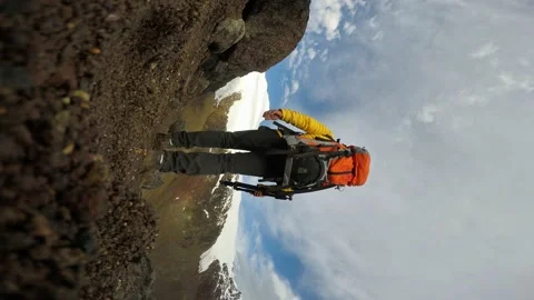Hikers on a summit in a wintry mountain landscape Stock Footage 229702912
