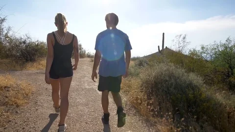 Hikers on a Trail Through the Desert Tracking Shot Stock Footage 81144694