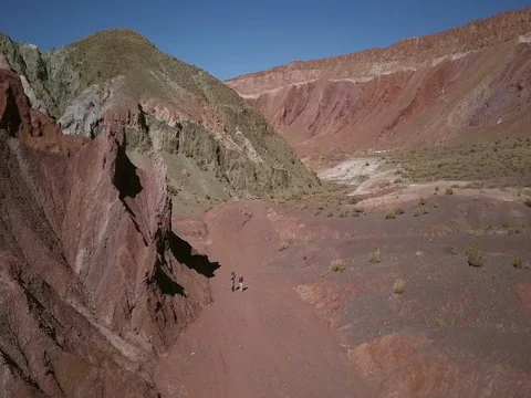 Hikers in Valle de Arco Iris aerial in Chile Stock Footage 83296217
