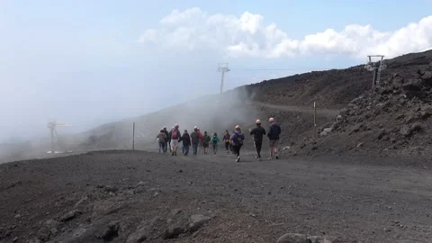 Hikers on a volcanic path of Mount Etna, Etna national park, Sicily, Italy. S Stock Footage 135631139