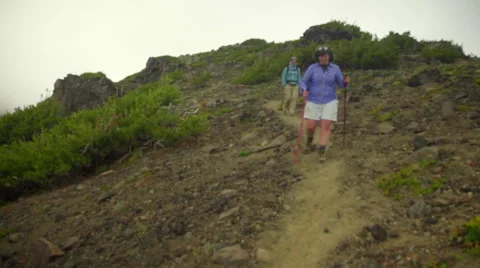 Hikers walk down from mountain Stock Footage 59517343