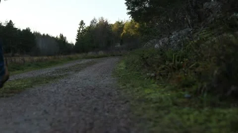 Hikers walk on a gravel road Stock Footage