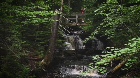 Hikers Walk Over Waterfall Stock Footage 78391071