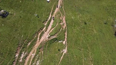 Hikers walking along path during trekking aerial shot view Stock Footage 142938625
