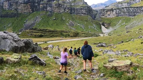 Hikers walking down trail in Ordesa natural park, Spain Stock Footage 252081231