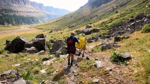 Hikers walking down trail in Ordesa natural park, Spain Stock Footage 252081241